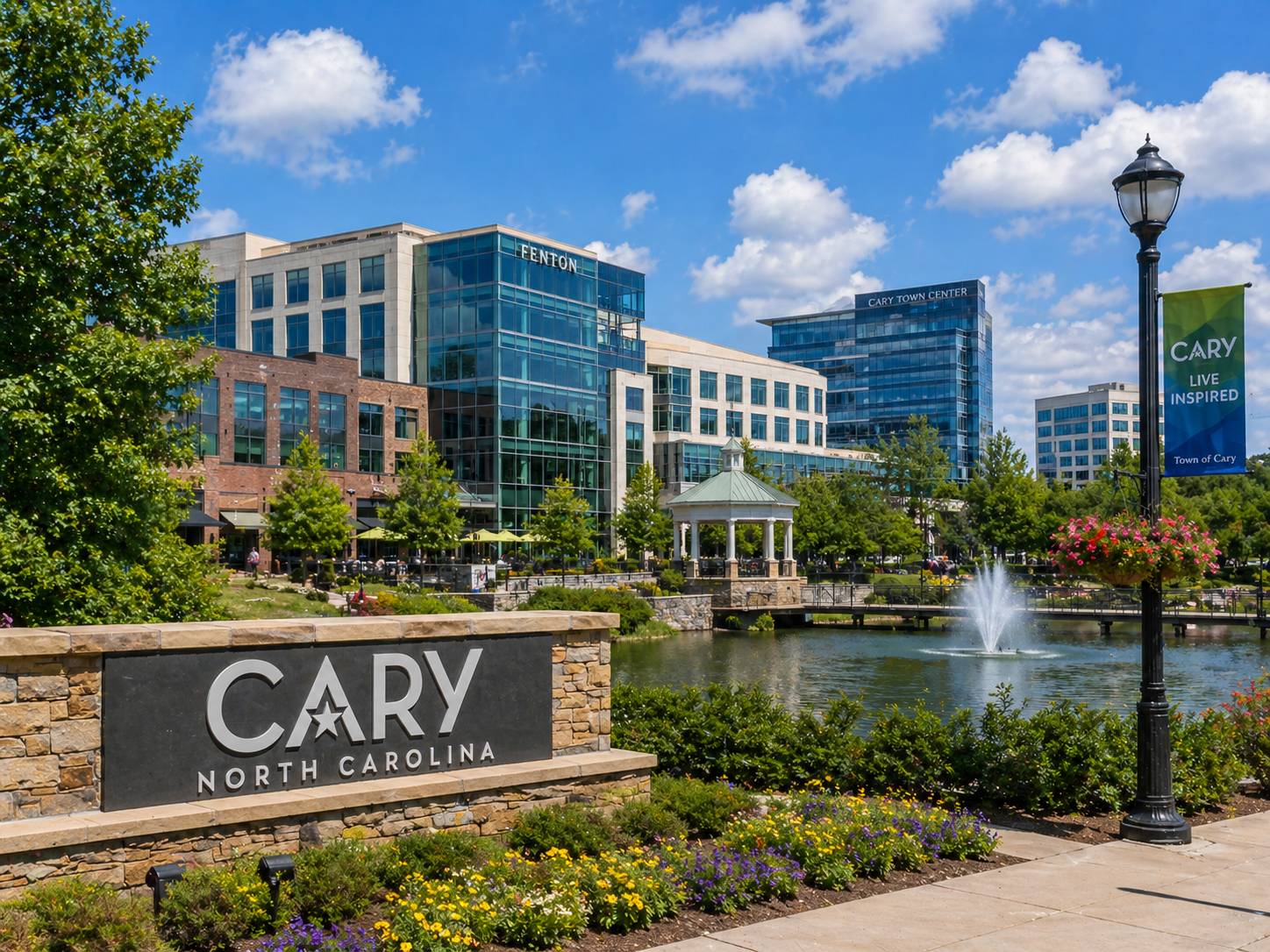 Cary, North Carolina welcome sign with modern buildings and fountain in a landscaped plaza
